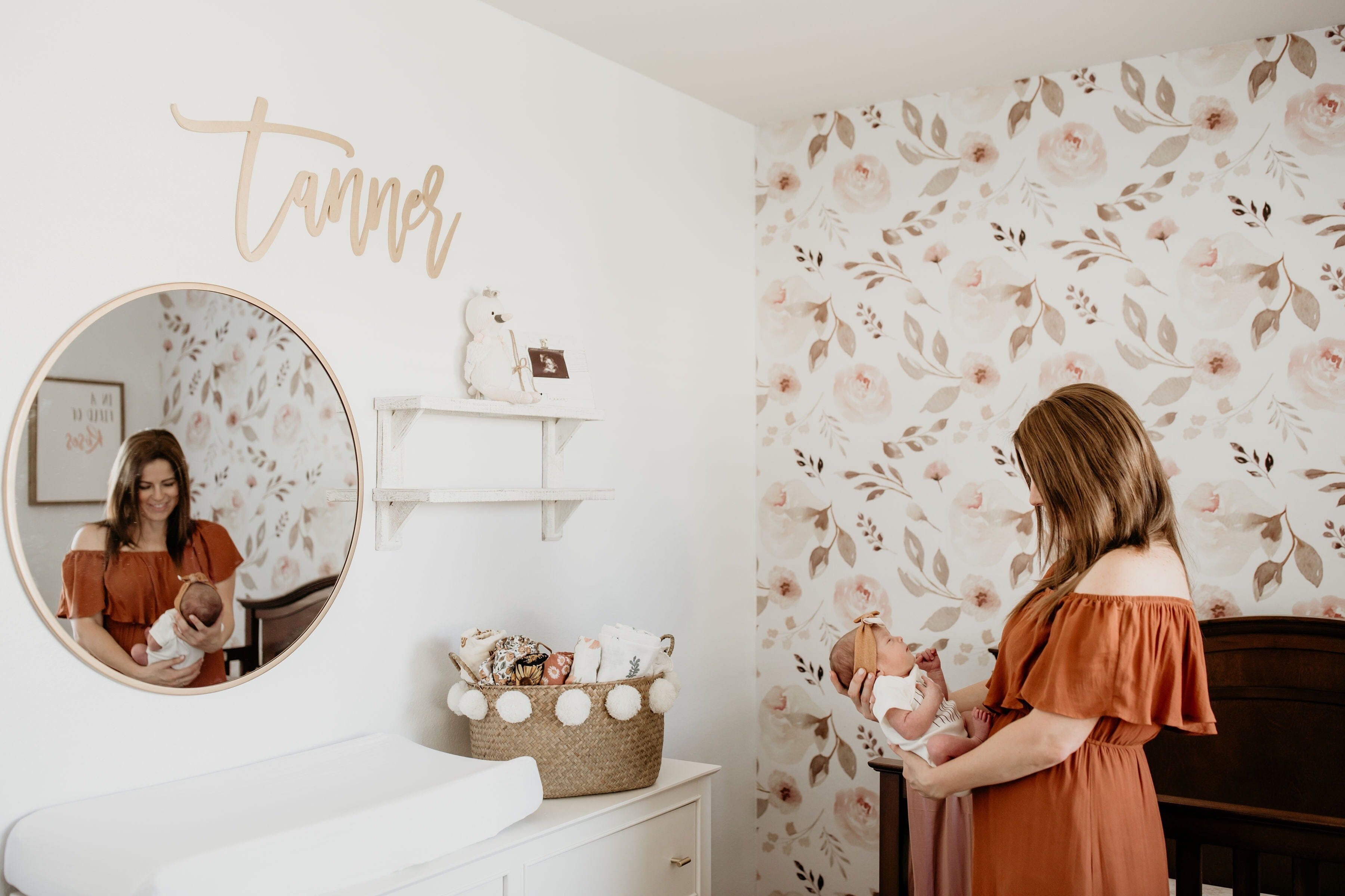 A Soft and Feminine Nursery Featuring Floral Wallpaper